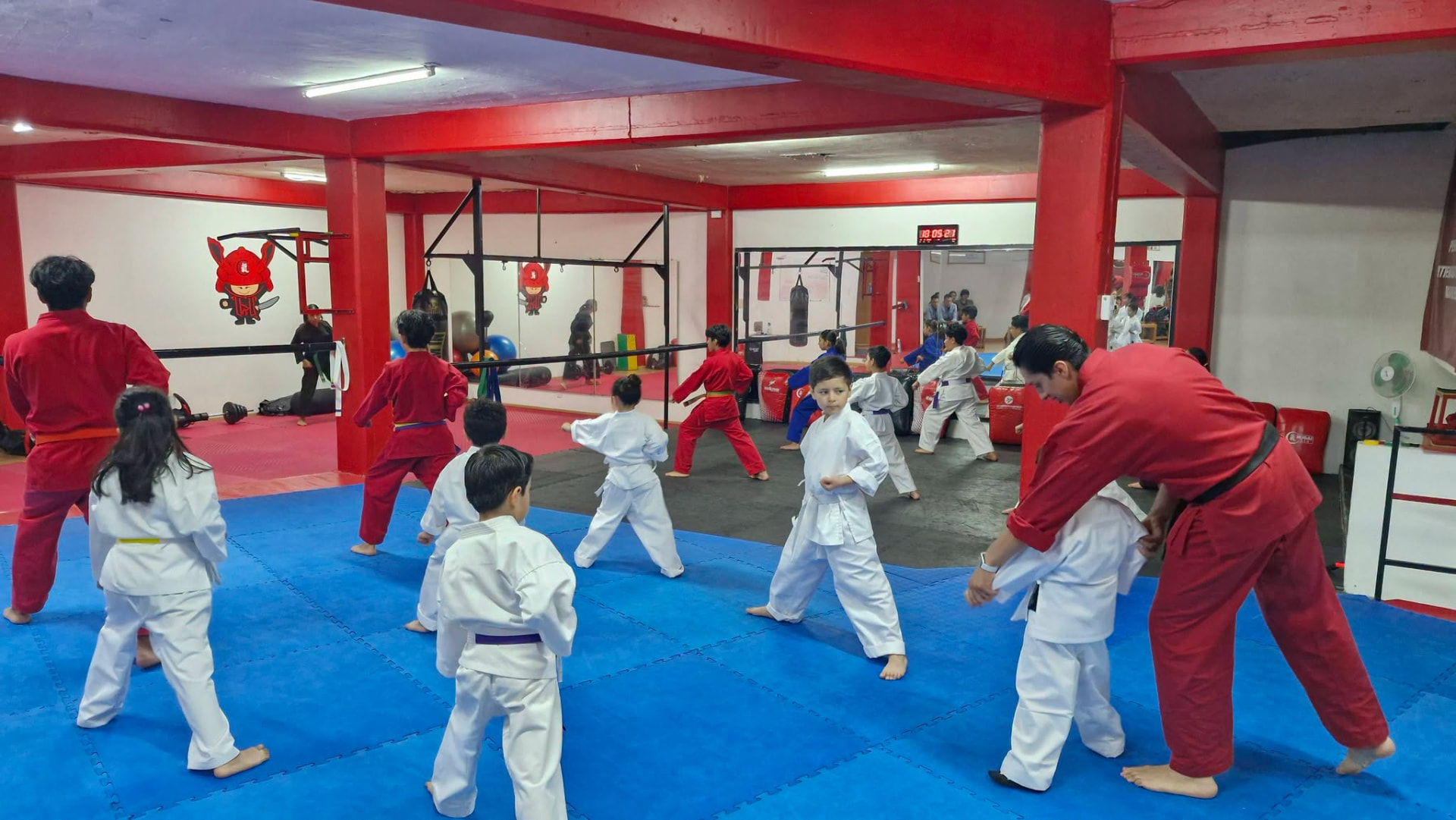 Niños en clase de karate con uniforme blanco en el dojo Ikigai