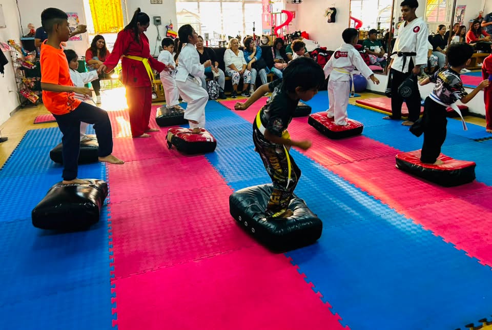 Niños entrenando equilibrio y saltos en clase de karate